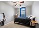 Bright bedroom with ceiling fan and window seat at 38169 N Rusty Ln, San Tan Valley, AZ 85140