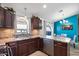 Modern kitchen with dark wood cabinets, stainless steel appliances, and an island at 38169 N Rusty Ln, San Tan Valley, AZ 85140