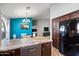Kitchen features an island, stainless steel dishwasher, and access to dining area at 38169 N Rusty Ln, San Tan Valley, AZ 85140