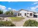 Landscaped backyard with a grassy area and rock features at 38169 N Rusty Ln, San Tan Valley, AZ 85140
