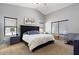 Main bedroom with a king-size bed, dark headboard, and ample natural light at 38169 N Rusty Ln, San Tan Valley, AZ 85140