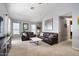 Open living room with two brown leather sofas and large windows at 38169 N Rusty Ln, San Tan Valley, AZ 85140