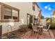 Small patio with seating area, umbrella, and partial view of the home's exterior at 3835 E Jasper Dr, Gilbert, AZ 85296