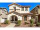 Two-story house with a light-colored facade, arched entryway, and landscaping at 3835 E Jasper Dr, Gilbert, AZ 85296