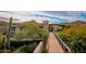 Stunning home exterior with mountain views and a wooden footbridge at 10801 E Happy Valley Rd # 132, Scottsdale, AZ 85255