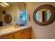 Bathroom with single vanity and large round mirror at 10801 E Happy Valley Rd # 132, Scottsdale, AZ 85255