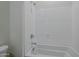 Bathroom with a shower/tub combo and white tile at 17978 W Long Lake Rd, Goodyear, AZ 85338