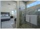 Glass shower with marble tile and view into bedroom at 17978 W Long Lake Rd, Goodyear, AZ 85338