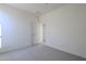 Clean and simple bedroom with an additional door at 17978 W Long Lake Rd, Goodyear, AZ 85338