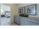 Gray bedroom cabinets and view into a bedroom with a bed at 17978 W Long Lake Rd, Goodyear, AZ 85338