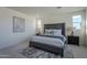 Main bedroom with gray upholstered bed and nightstands at 17978 W Long Lake Rd, Goodyear, AZ 85338