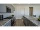 Modern kitchen with gray cabinets, marble countertops, and stainless steel appliances at 17978 W Long Lake Rd, Goodyear, AZ 85338