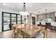 Elegant dining area with large table, modern chandelier, and backyard access at 3102 N 81St Pl, Scottsdale, AZ 85251