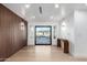 Bright and airy entryway with wood feature wall and modern light fixtures at 3102 N 81St Pl, Scottsdale, AZ 85251