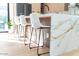 Kitchen island with white barstools and marble top at 3102 N 81St Pl, Scottsdale, AZ 85251