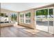 Bright sunroom with wood floors and sliding glass doors leading to the backyard at 8128 E Emelita Ct, Mesa, AZ 85208