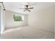 Bright bedroom with carpeted floors and large window, offering ample natural light at 8128 E Emelita Ct, Mesa, AZ 85208