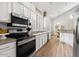 White kitchen cabinets, stainless steel appliances, and a breakfast nook at 9056 E Maple Dr, Scottsdale, AZ 85255