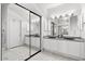 Double vanity bathroom with a large mirror and sliding door at 9056 E Maple Dr, Scottsdale, AZ 85255