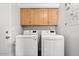 Bright laundry room with LG washer and dryer and wooden cabinets at 9056 E Maple Dr, Scottsdale, AZ 85255