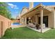 Artificial turf, covered patio, pool, and seating at 9056 E Maple Dr, Scottsdale, AZ 85255