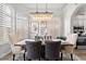 Bright dining room with a large chandelier and rustic wooden table at 9056 E Maple Dr, Scottsdale, AZ 85255