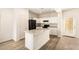 Modern kitchen with white cabinets and black appliances at 913 E Agua Fria Ln, Avondale, AZ 85323