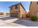 Tan two-story home with a two car garage at 913 E Agua Fria Ln, Avondale, AZ 85323