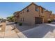 Tan two-story home with a two car garage at 913 E Agua Fria Ln, Avondale, AZ 85323