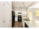 Modern kitchen with white cabinets and black appliances at 913 E Agua Fria Ln, Avondale, AZ 85323