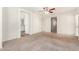 Spacious bedroom with carpeting and access to bathroom and hallway at 913 E Agua Fria Ln, Avondale, AZ 85323