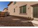 Small gravel backyard with a wooden fence and access door at 913 E Agua Fria Ln, Avondale, AZ 85323