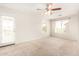 Bright bedroom with carpeted floor and access to a balcony at 913 E Agua Fria Ln, Avondale, AZ 85323