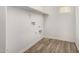Laundry room with wood-look flooring and shelving at 913 E Agua Fria Ln, Avondale, AZ 85323