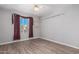 Bright bedroom with wood-look floors and ceiling fan at 441 E Saratoga St, Gilbert, AZ 85296