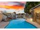 Stunning pool and spa overlooking a tranquil lake at sunset at 1243 E Artesian Way, Gilbert, AZ 85234