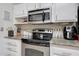 Well-equipped kitchen with stainless steel appliances and ample counter space at 9901 W Kingswood Cir, Sun City, AZ 85351