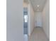 Bright hallway with tile flooring and access to other rooms at 17984 W Long Lake Rd, Goodyear, AZ 85338