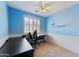Home office with built-in desk and chair, plus ceiling fan at 14588 W Laurel Ln, Surprise, AZ 85379