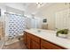 Bathroom features a shower/tub, wood vanity, and whale-themed decor at 14588 W Laurel Ln, Surprise, AZ 85379