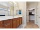 Bathroom boasts double vanity, linen closet, and tile flooring at 14588 W Laurel Ln, Surprise, AZ 85379