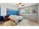 Serene bedroom with accent wall and ample window light at 14588 W Laurel Ln, Surprise, AZ 85379