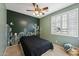Bedroom with cactus-themed wall and ceiling fan at 14588 W Laurel Ln, Surprise, AZ 85379