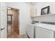 Laundry room with washer, dryer, and extra shelving at 14588 W Laurel Ln, Surprise, AZ 85379