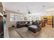 Open concept living room with kitchen views and L-shaped sofa at 14588 W Laurel Ln, Surprise, AZ 85379