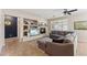 Spacious living room with a fireplace and built-in shelving at 14588 W Laurel Ln, Surprise, AZ 85379