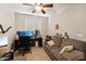 Home office space with desk, chair and comfortable seating at 14588 W Laurel Ln, Surprise, AZ 85379