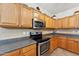 Modern kitchen with dark countertops and ample cabinetry at 14588 W Laurel Ln, Surprise, AZ 85379