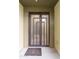 Modern front door with glass panels and welcome mat at 7788 E Main St # 1002, Scottsdale, AZ 85251