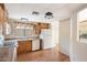 View of kitchen with wood cabinets and white appliances at 9302 E Broadway Rd # 42, Mesa, AZ 85208